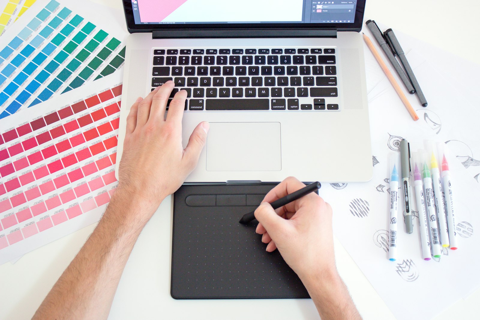 Design workspace with colour swatches and a drawing tablet